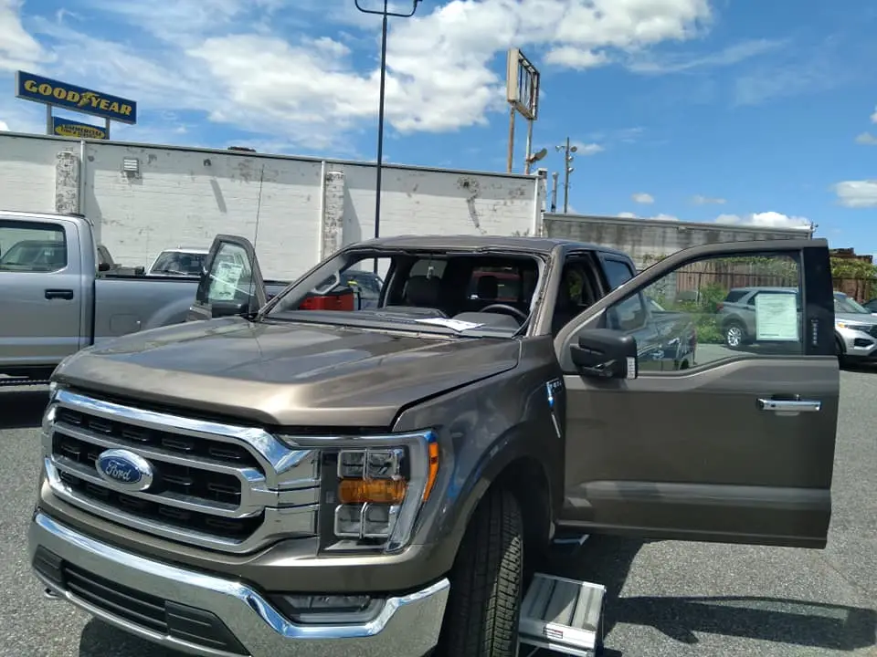 Ford F-150 truck prepared for windshield replacement by an auto glass technician, ensuring safe installation and proper fitment of new glass,