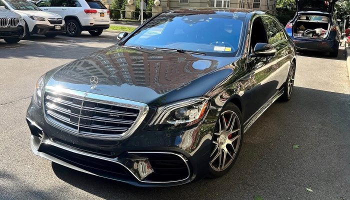 Black Mercedes-Benz sedan parked outdoors, showcasing the windshield and front glass area for auto glass repair and replacement services.